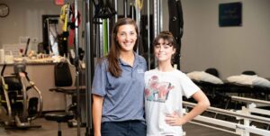 Chronic foot pain patient , Ella Cauley, poses with PT Mallory Behenna in the dance studio.