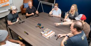 Brain injury patients in Brooks brain injury clubhouse play board games.