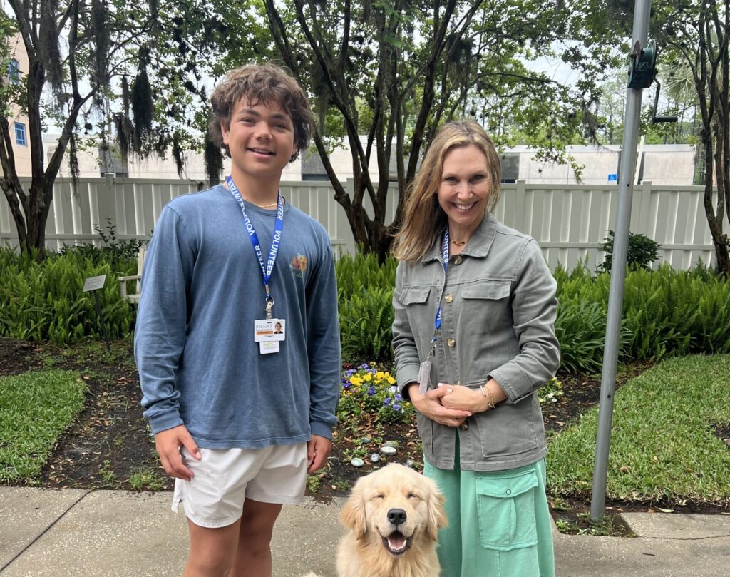 volunteers at brooks walk a golden retriever service dog.