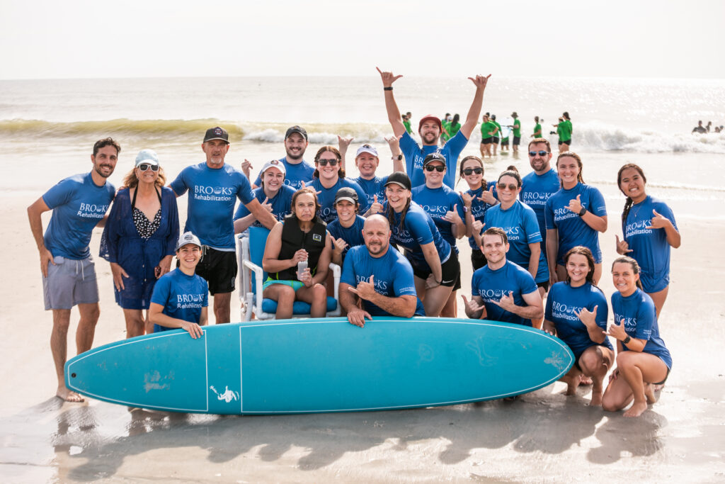 Volunteers with surfboard at surf event