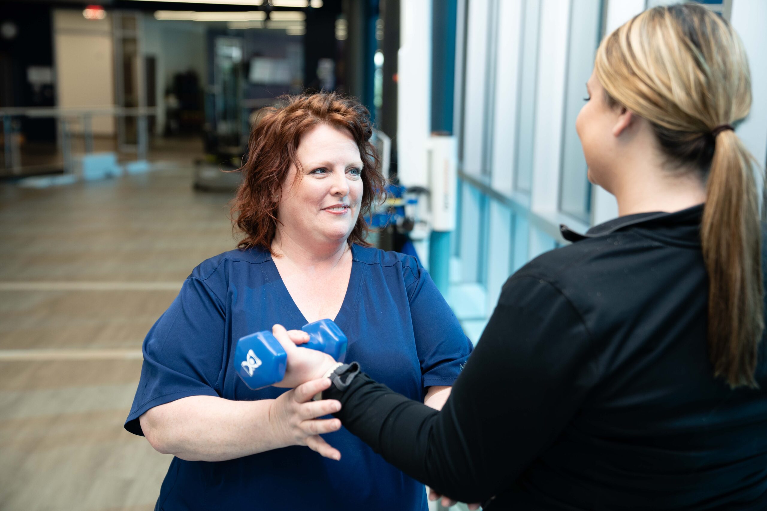 occupational therapist works with a patient in an outpatient clinic.