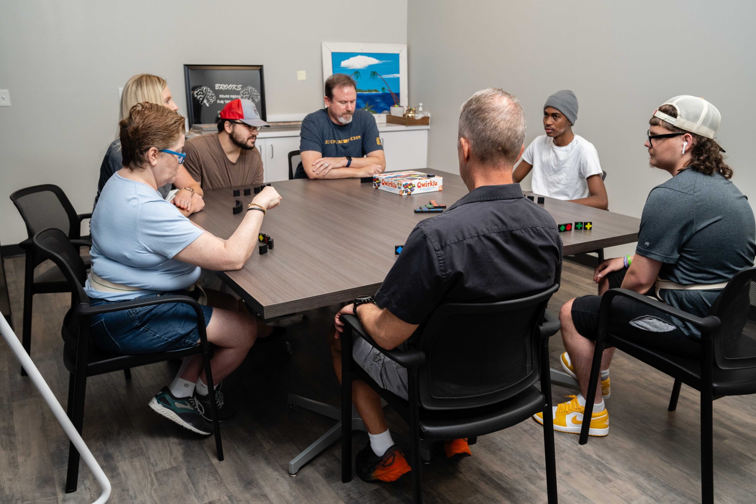 patients sit around a table participating in group therapy in the behavioral medicine department