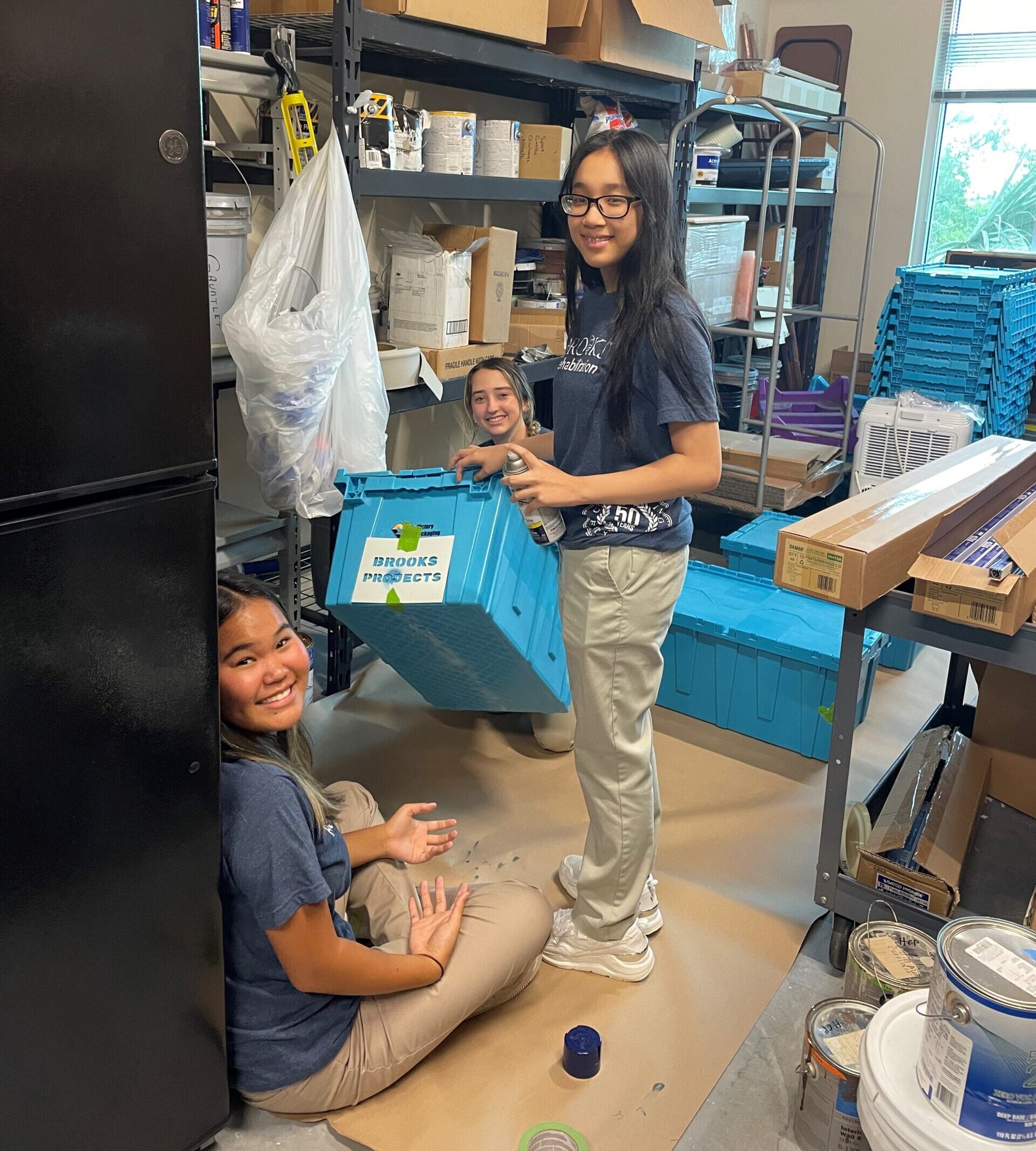 Teens in the volunteen program at brooks assist in packing boxes.