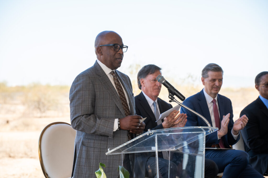 Eric Mann, board chairman, Brooks Rehabilitation, stands a podium with mic.