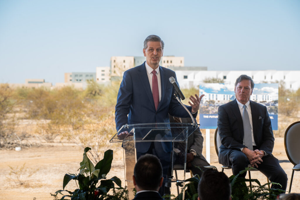 Richard Gray, MD, CEO of Mayo Clinic in Arizona, stands at podium with mic.