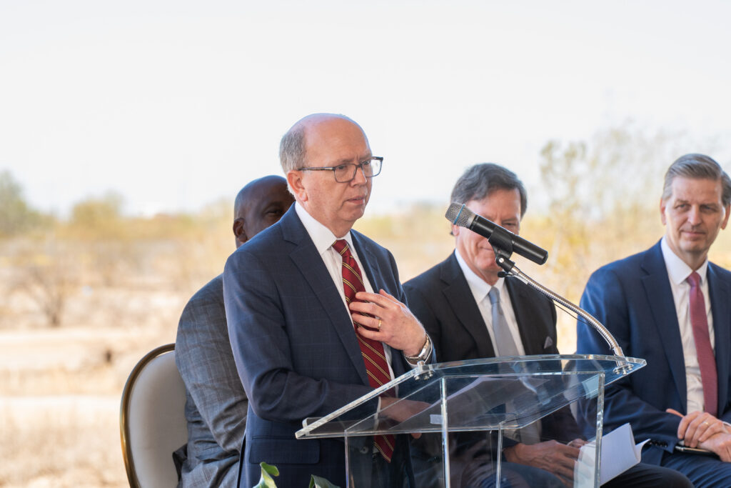 Dr. Trevor Paris, system chief medical officer for Brooks Rehabilitation stands at a podium with mic.