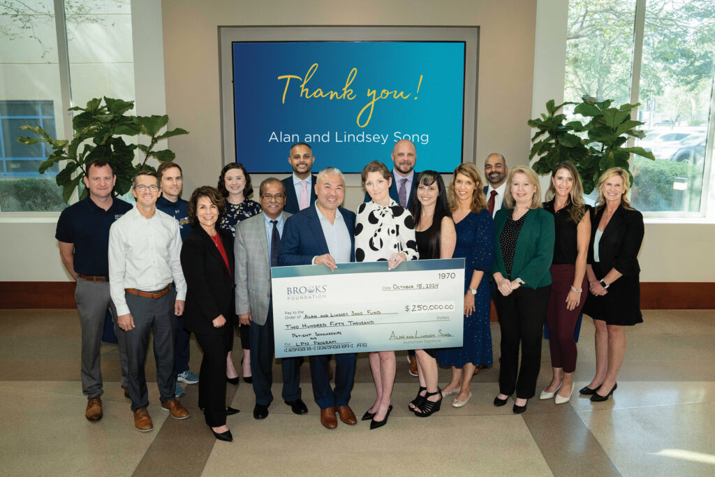 Lindsey Song presenting Brooks Foundation and team with a donation check.