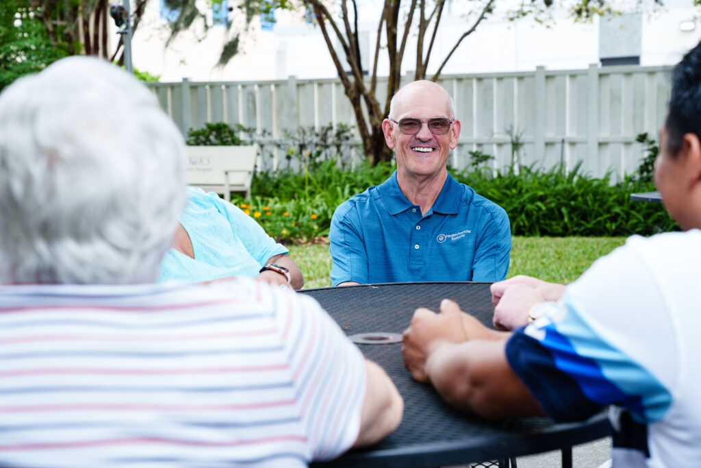 Brooks peer mentors sit around an outside table.