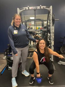 Candy with therapist in squatting with kettle bell