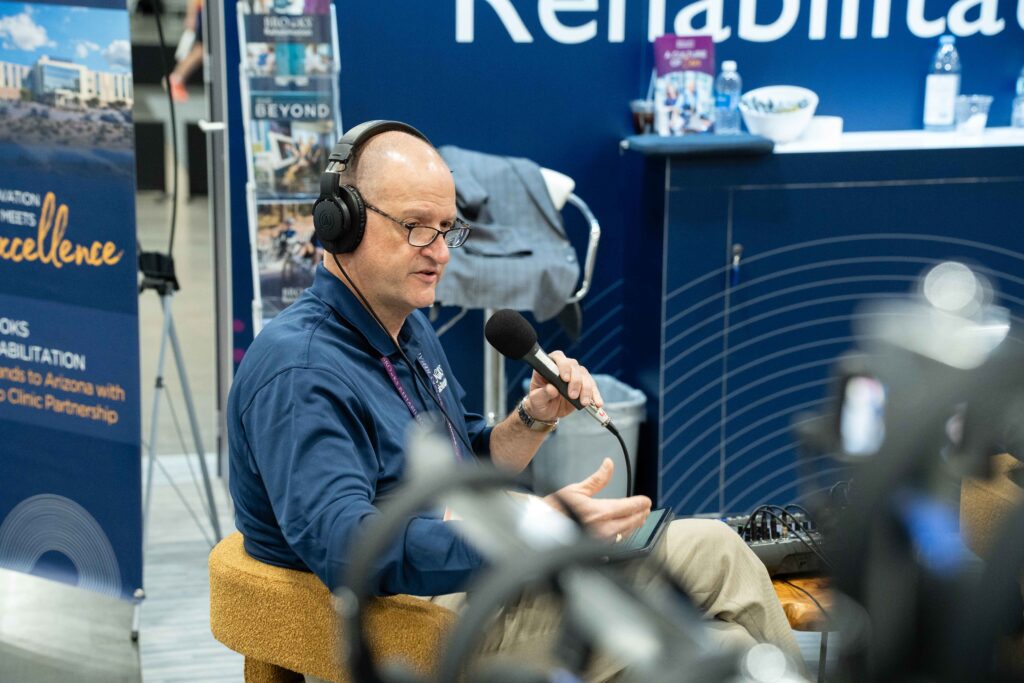 Man with microphone and headset recording podcast