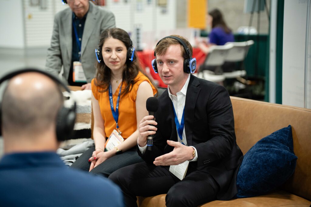 Man and woman with microphone and headset recording podcast
