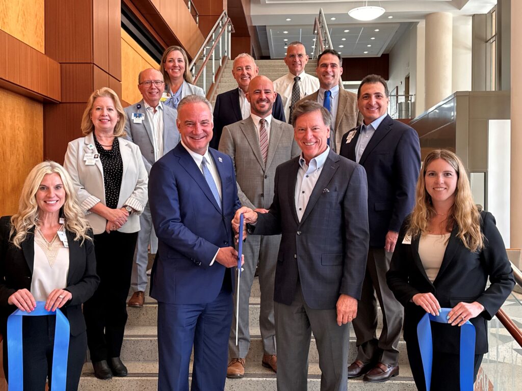 Executives from Brooks Rehabilitation and Halifax Health cut a ribbon in celebration of opening 12 new beds to the Center for Inpatient Rehabilitation