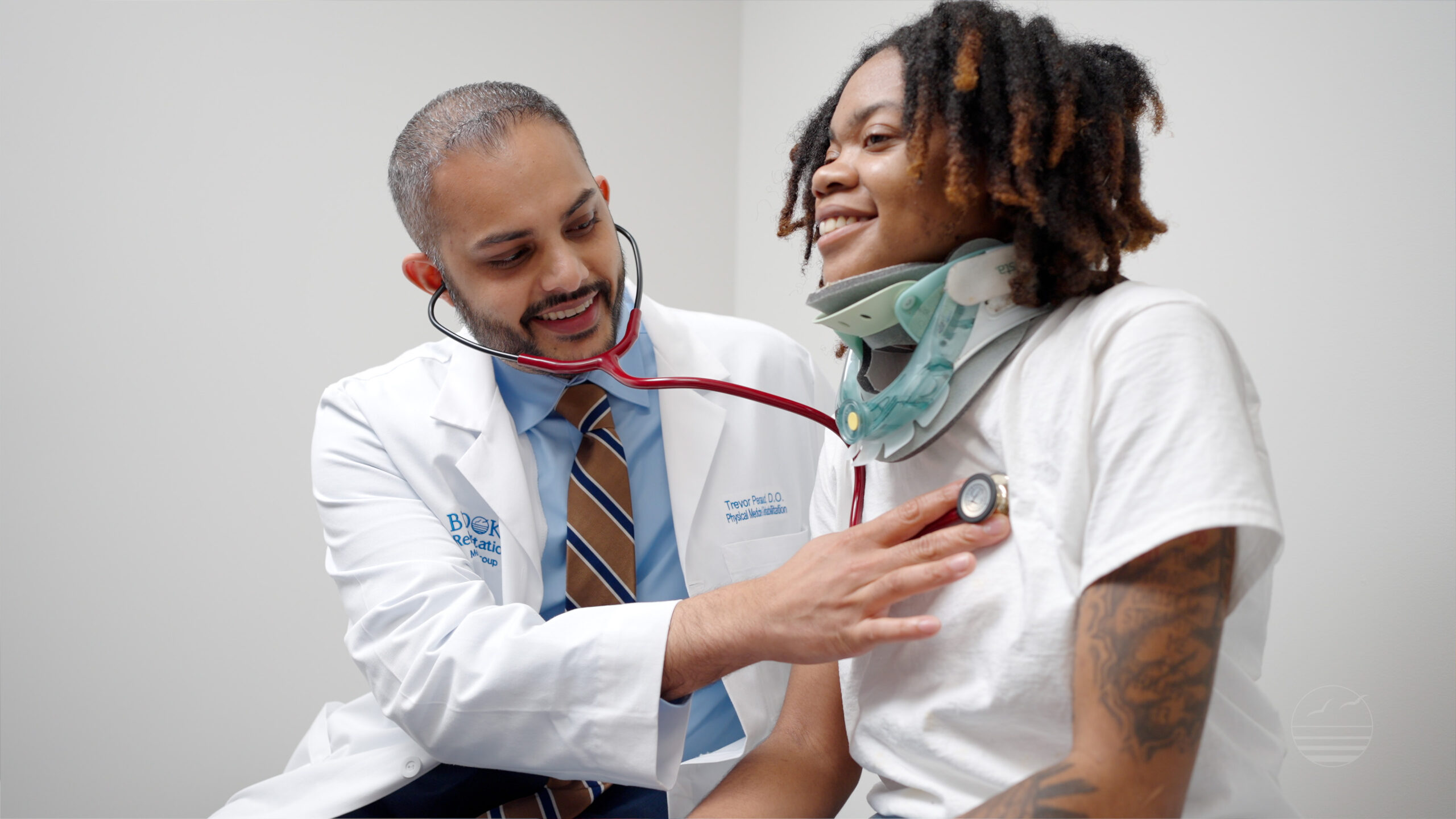 Dr. Persaud listening to patient's heart