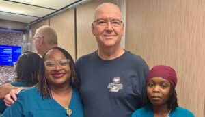 Jon Daser posing with two Brooks employees