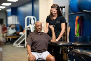 Mallory Behenna working with patient holding a dumbbell