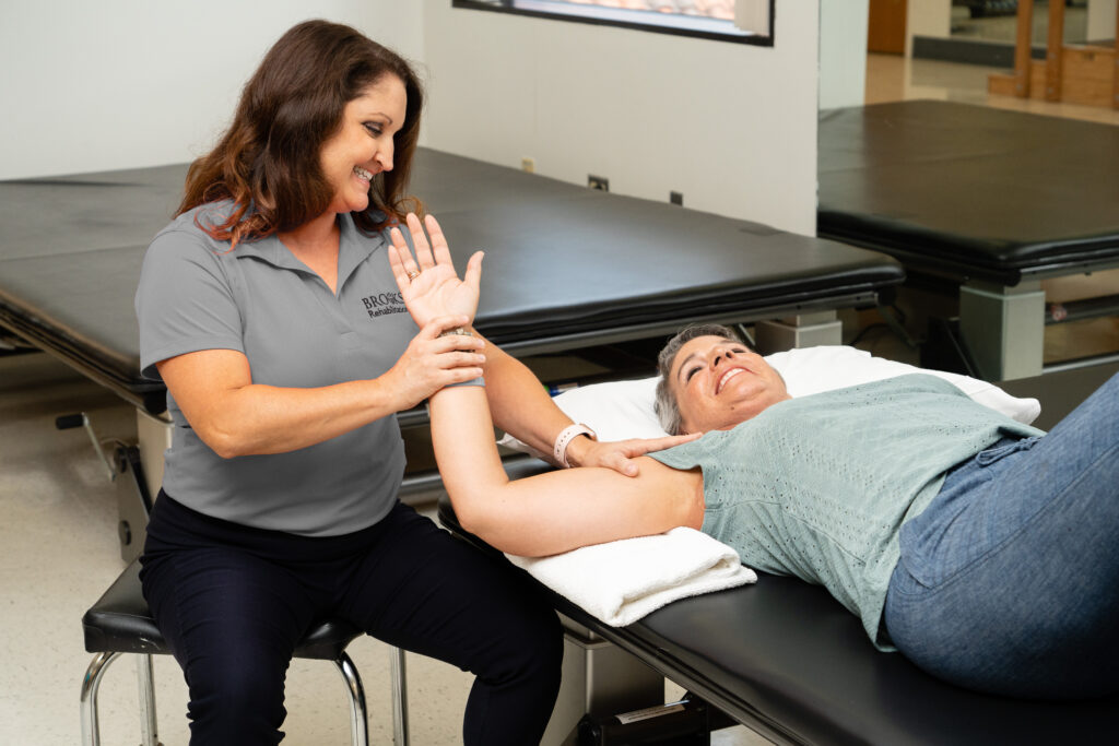 Cancer patient receiving therapy laying on table with arm up
