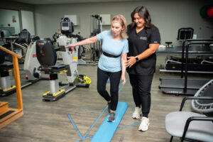 Brain tumor patient works on balance exercises with a physical therapist.