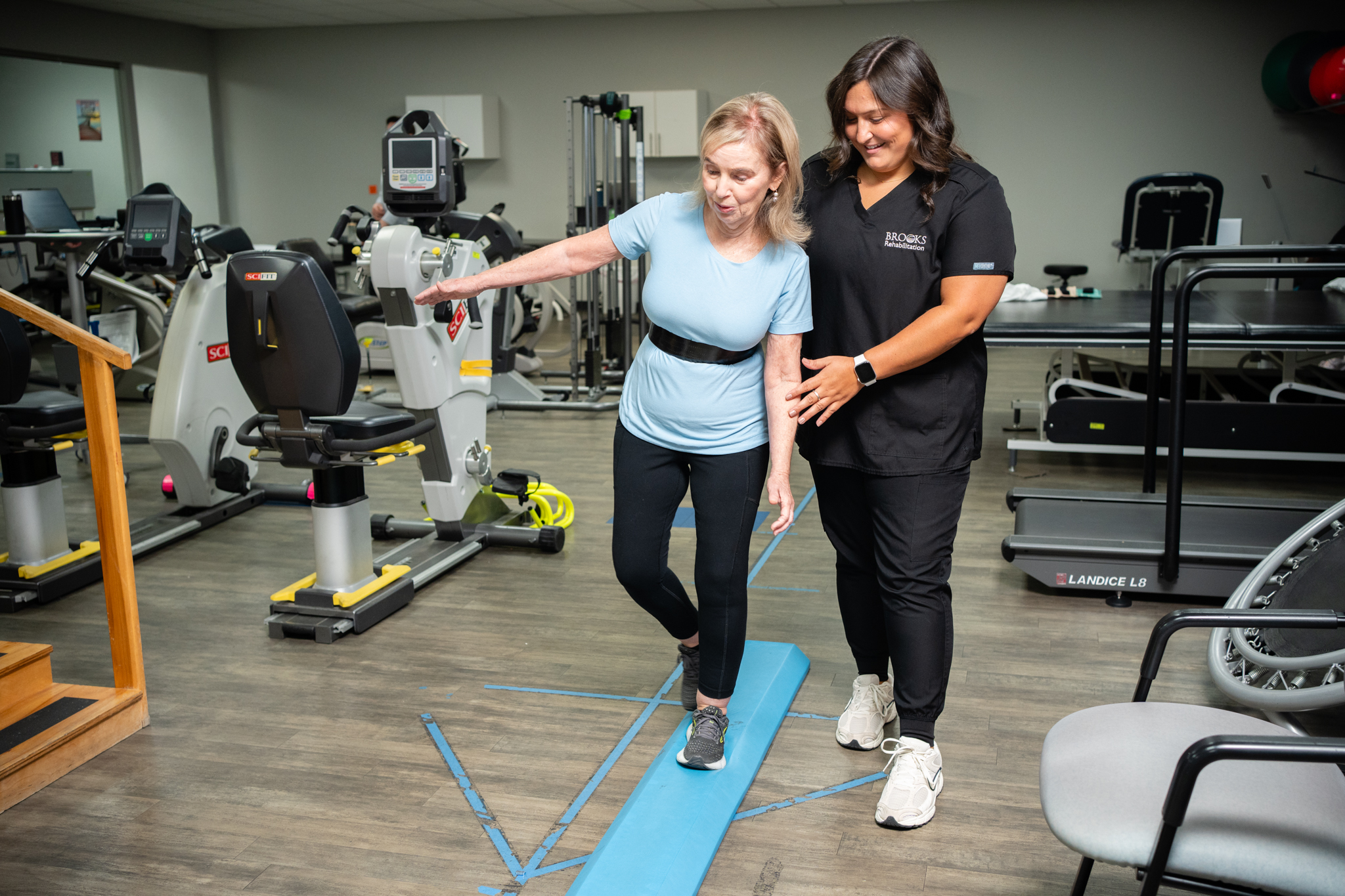 Brain tumor patient works on balance exercises with a physical therapist.