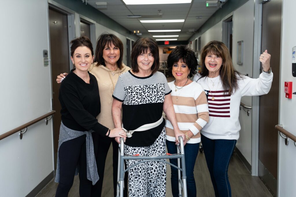 Nan Conway and family stand in hospital cheering