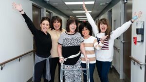 Nan Conway and family stand in hospital cheering