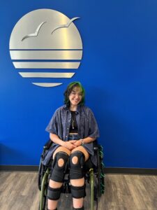 Izzy posing in front of Brooks sign