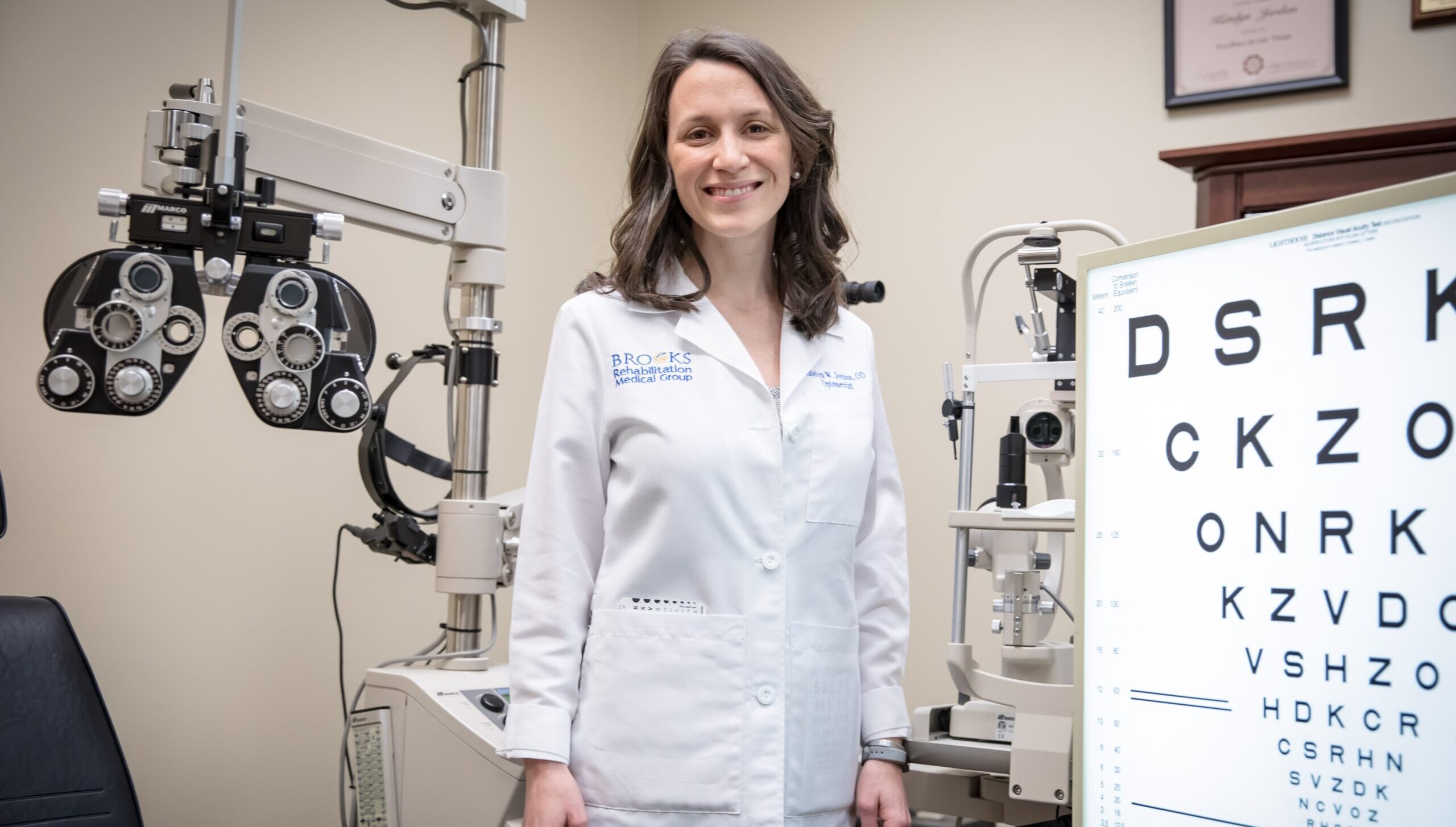 Dr. Katelyn Jordan posing with low vision equipment