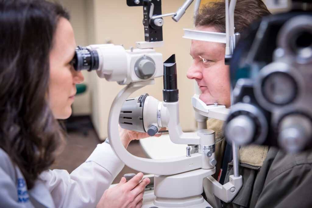 Dr. Katelyn Jordan looking at patient's eyes with low vision technology