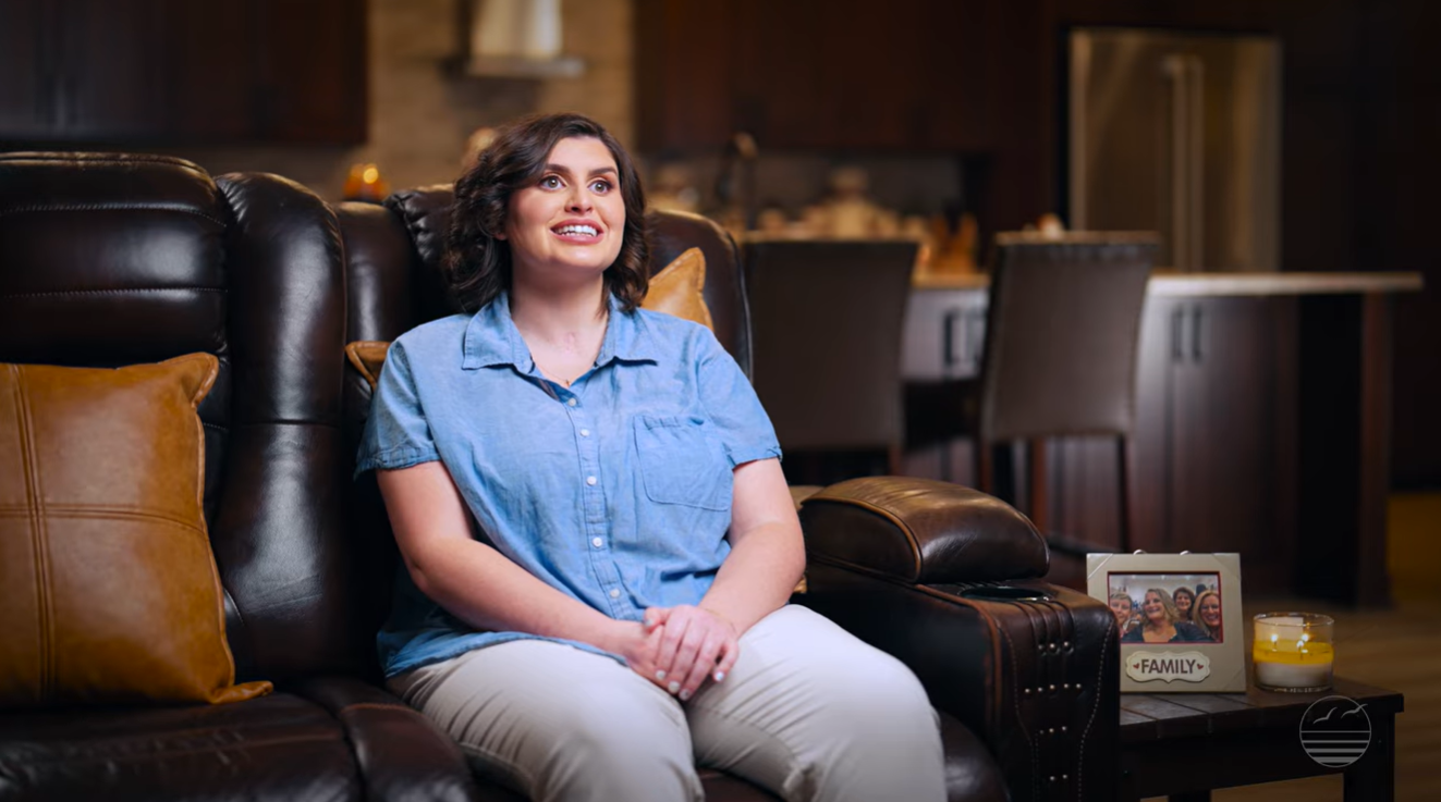 Sarah Giber sitting and smiling while being interviewed