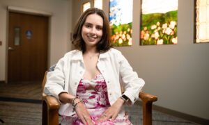 Victoria Pooz sitting in chair and smiling