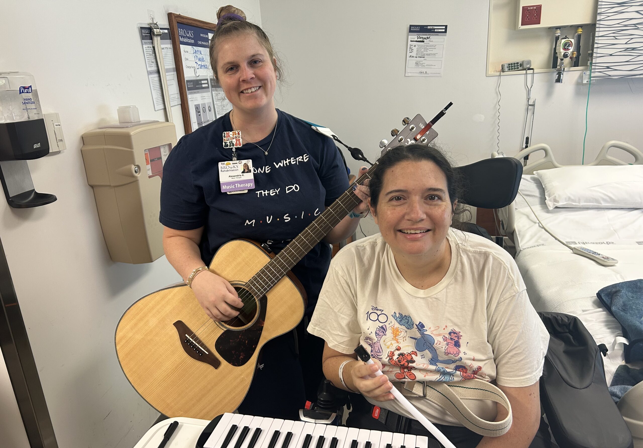 Music therapist with guitar and patient in front of piano
