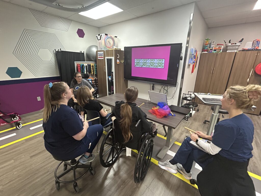 Patients and therapists gathered in front of a TV