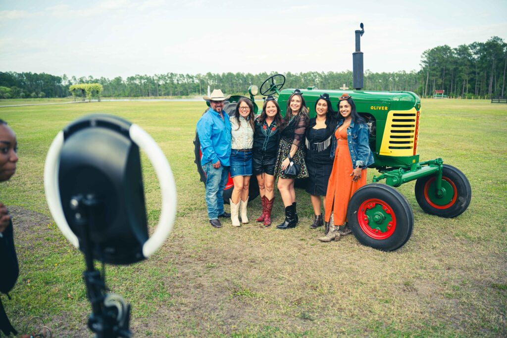 people posing in front of tractor with ring light