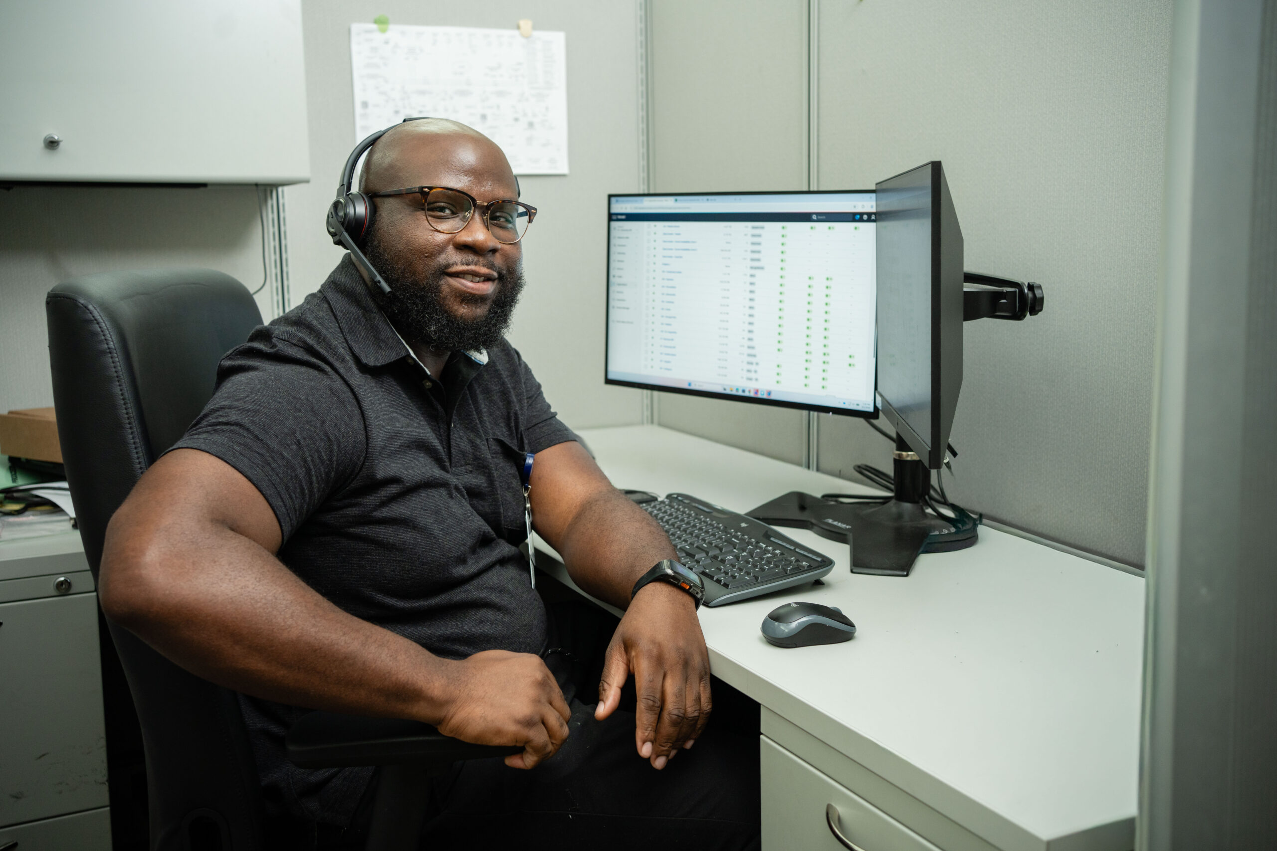 Dean Ojo sitting at desk with headphones