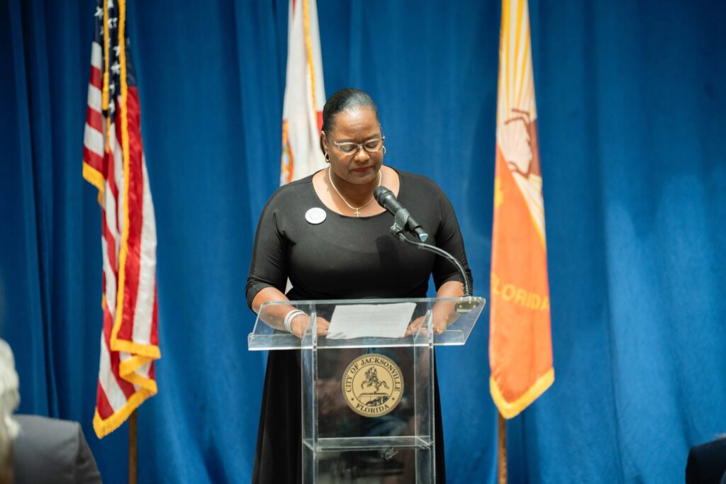 Woman speaking with podium at proclamation
