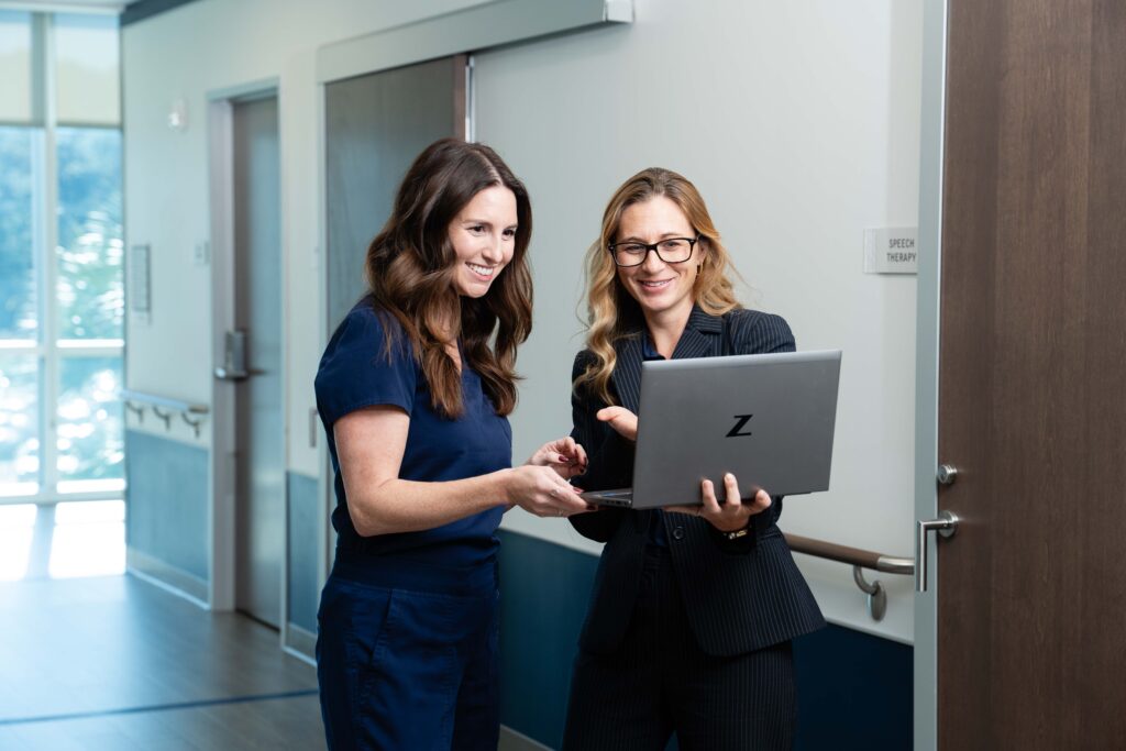 A therapist reviews data with a researcher for better care outcomes.