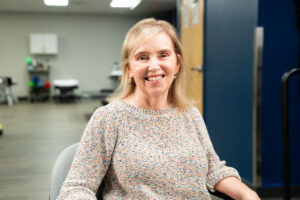 Deborah Plews smiling in therapy gym
