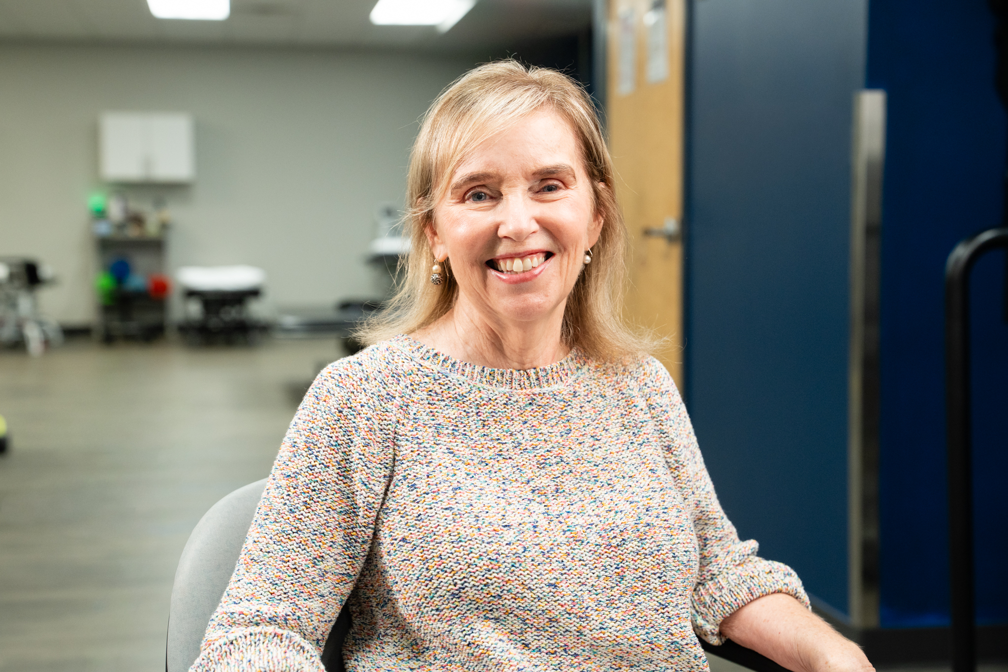 Deborah Plews smiling in therapy gym