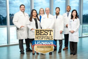 Physicians posing with US News badge