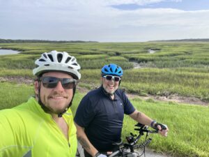 two men biking in the marsh