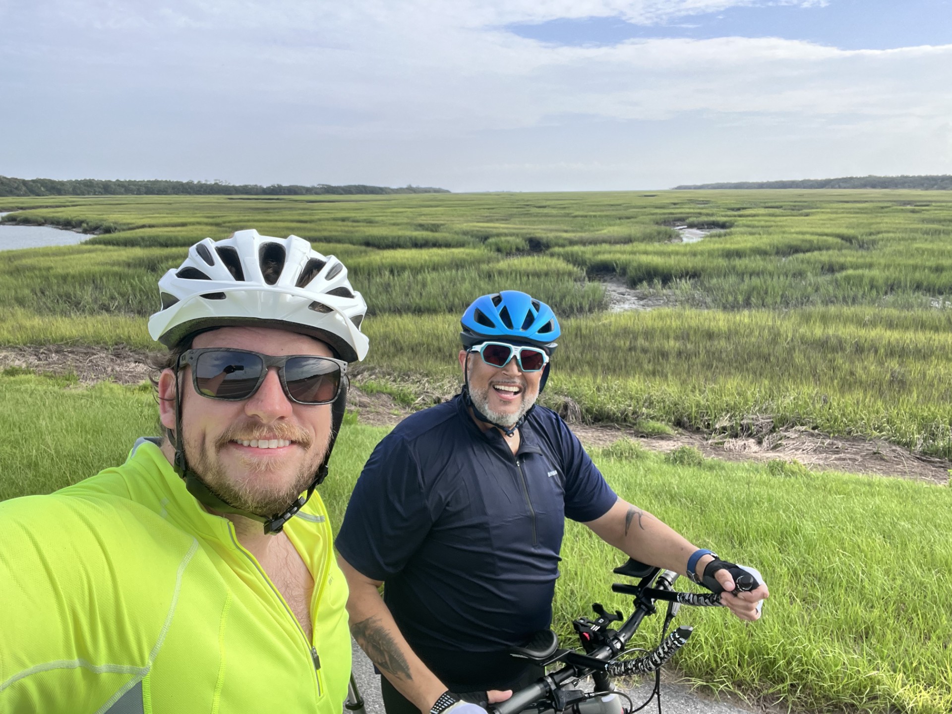 two men biking in the marsh